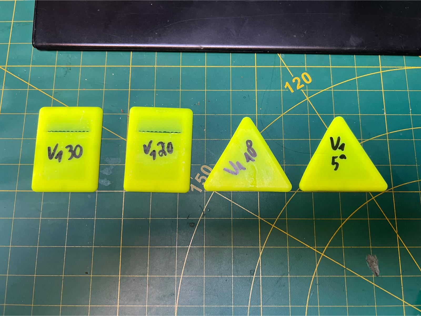3D-printed test parts on a cutting mat